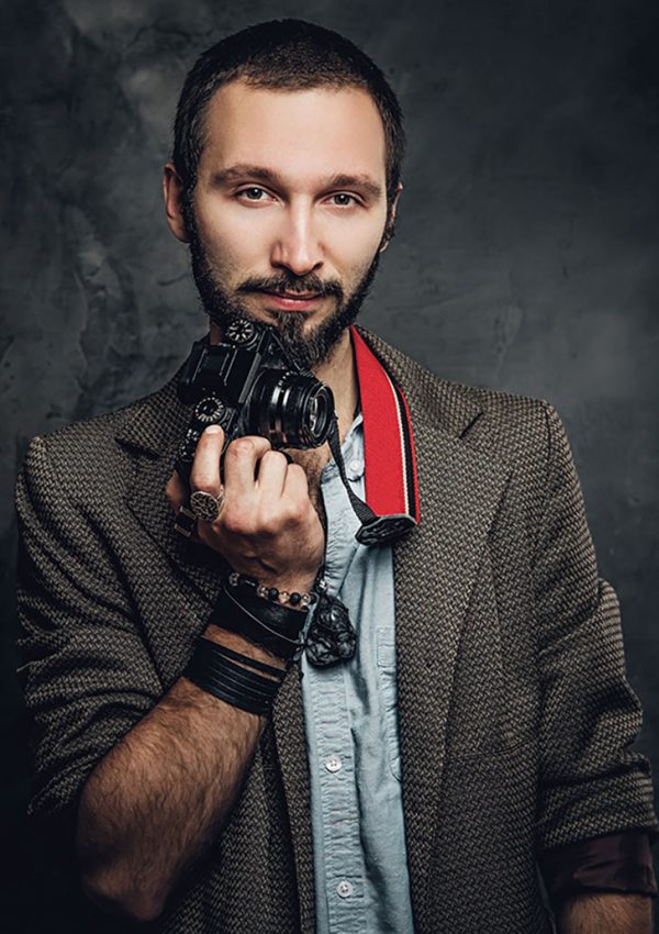 man-is-posing-for-photographer-with-photo-camera-resize.jpg